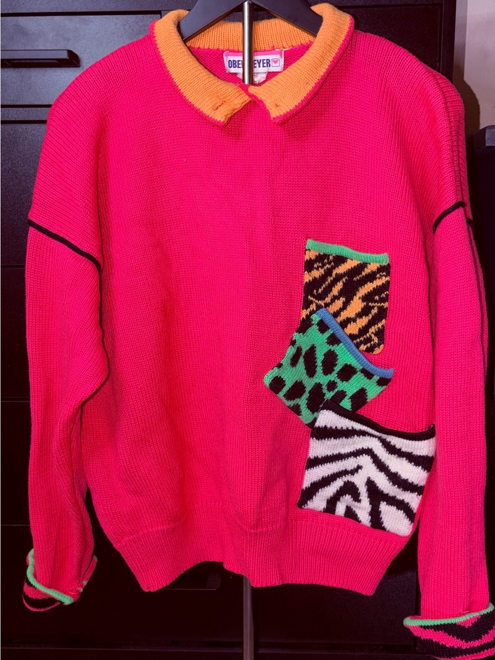 Hot Pink Crewneck ski Sweater with Orange Collar and Animal-Print Patch Pockets